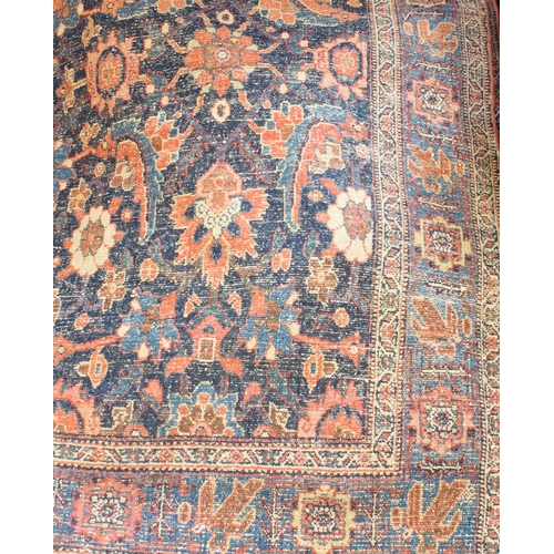 595 - A circa 1900 north-west Persian Feraghan rug; dark-blue field with Herati design in blue and red wit... 