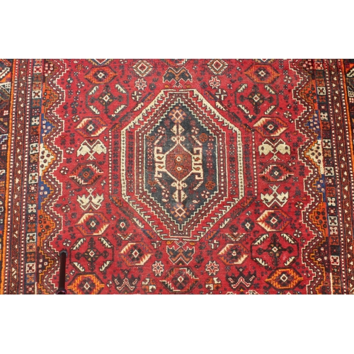 596 - A south-west Persian Shiraz rug: probably 20th century, the central eight sided medallion on a six-s... 