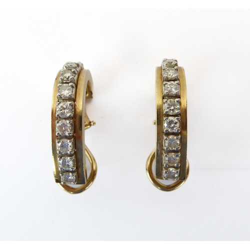 209 - A pair of 14ct two-colour gold and diamond half hoop earrings - each set with a row of nine brillian... 