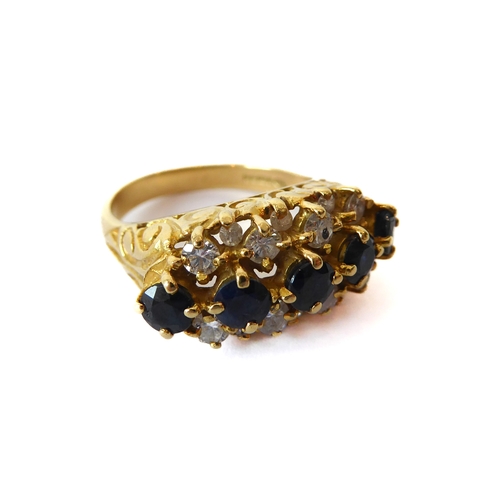 242 - An 18ct yellow gold, sapphire and diamond three row ring - hallmarked Birm. 1992, with a central row... 