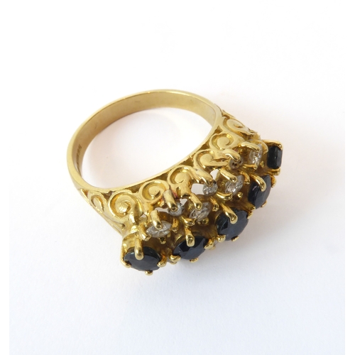 242 - An 18ct yellow gold, sapphire and diamond three row ring - hallmarked Birm. 1992, with a central row... 