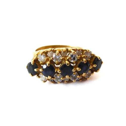 242 - An 18ct yellow gold, sapphire and diamond three row ring - hallmarked Birm. 1992, with a central row... 