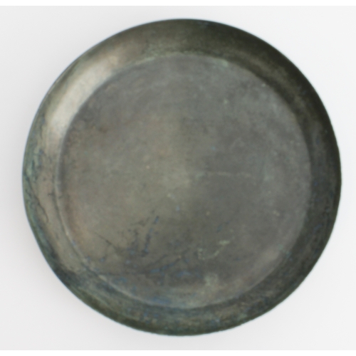 56 - An antique Chinese bronze mirror or dish: of dished circular form, the upper surface undecorated, th... 