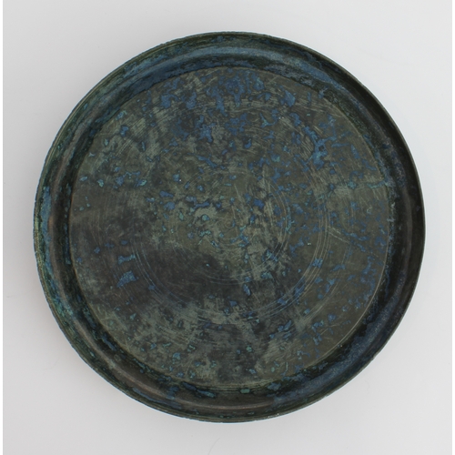 56 - An antique Chinese bronze mirror or dish: of dished circular form, the upper surface undecorated, th... 