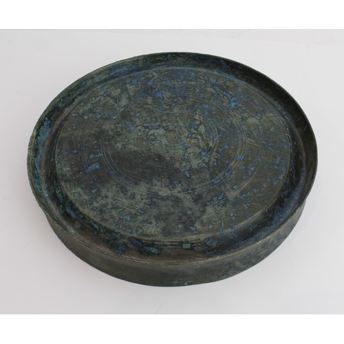 56 - An antique Chinese bronze mirror or dish: of dished circular form, the upper surface undecorated, th... 