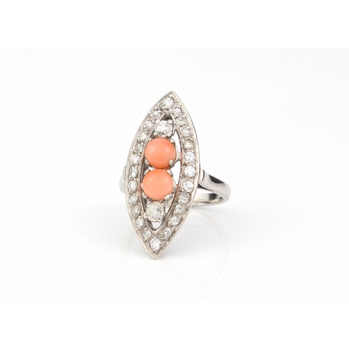 206 - An 18ct white gold, coral and diamond marquise cluster ring - unmarked, tests as 18ct, set to the ce... 