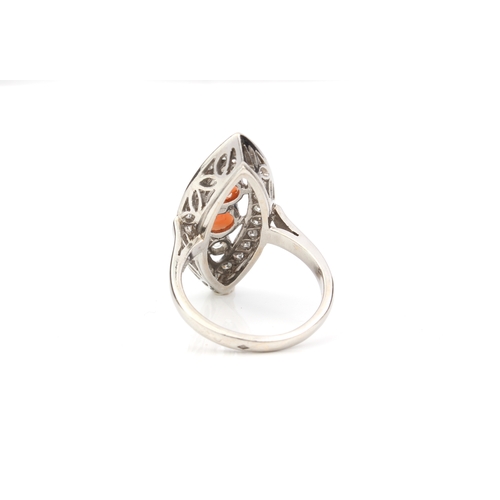 206 - An 18ct white gold, coral and diamond marquise cluster ring - unmarked, tests as 18ct, set to the ce... 