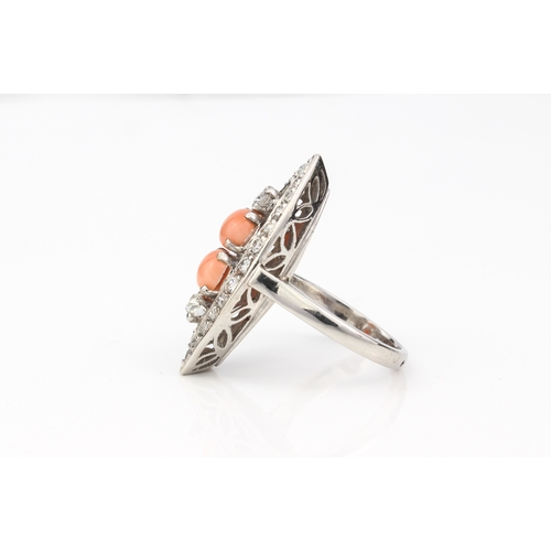 206 - An 18ct white gold, coral and diamond marquise cluster ring - unmarked, tests as 18ct, set to the ce... 