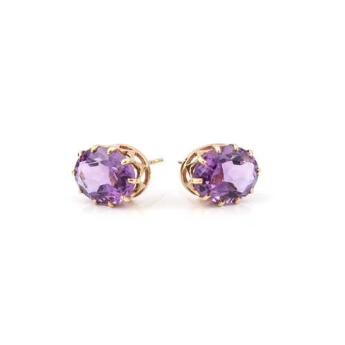 224 - A pair of 9ct gold and amethyst stud earrings - the 10 x 7.75mm oval cut amethysts in basket setting... 