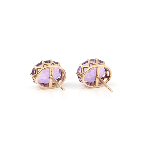 224 - A pair of 9ct gold and amethyst stud earrings - the 10 x 7.75mm oval cut amethysts in basket setting... 