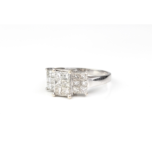 249 - An 18ct white gold and diamond ring - the stepped setting with eighteen Princess cut diamonds, total... 