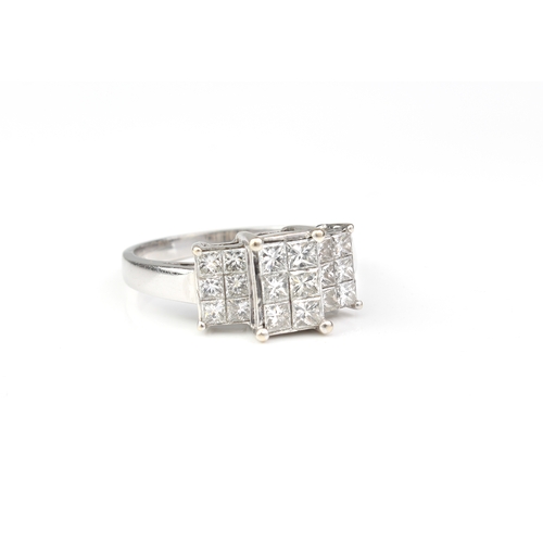 249 - An 18ct white gold and diamond ring - the stepped setting with eighteen Princess cut diamonds, total... 