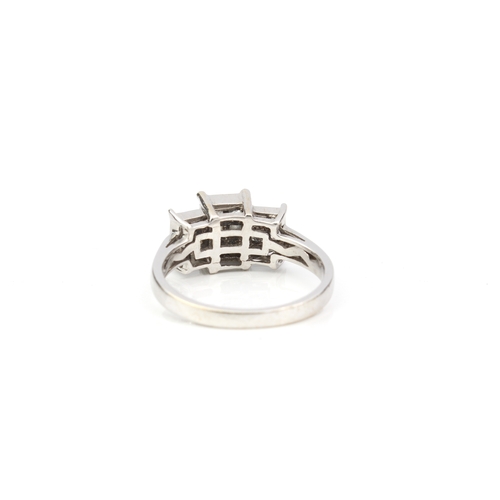 249 - An 18ct white gold and diamond ring - the stepped setting with eighteen Princess cut diamonds, total... 