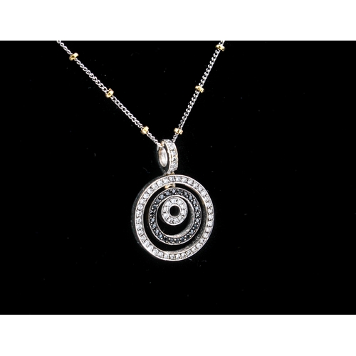 250 - An 18ct white gold and black and white diamond pendant necklace - in the style of Van Cleef & Arpels... 