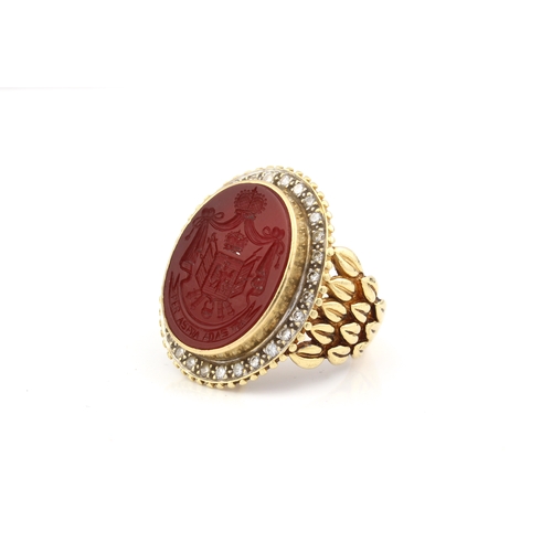 214 - An 18ct yellow gold, carnelian intaglio and diamond signet ring - marked '18K', the oval carnelian i... 