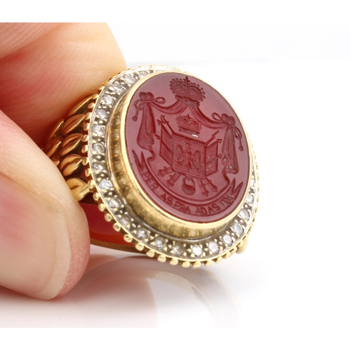 214 - An 18ct yellow gold, carnelian intaglio and diamond signet ring - marked '18K', the oval carnelian i... 