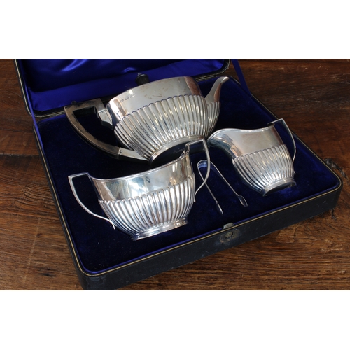 164 - A three-piece hallmarked silver tea service in Georgian style in its original fitted case. Each piec... 