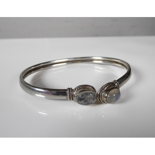 238 - A collection of silver bangles - including a torc style bangle set with two cabochon moonstones; a s... 