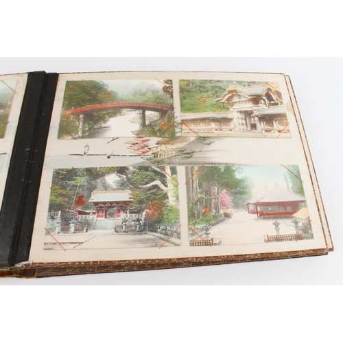 68 - A Japanese lacquer postcard album - 1920s-30s, the black lacquer cover decorated with a handpainted ... 