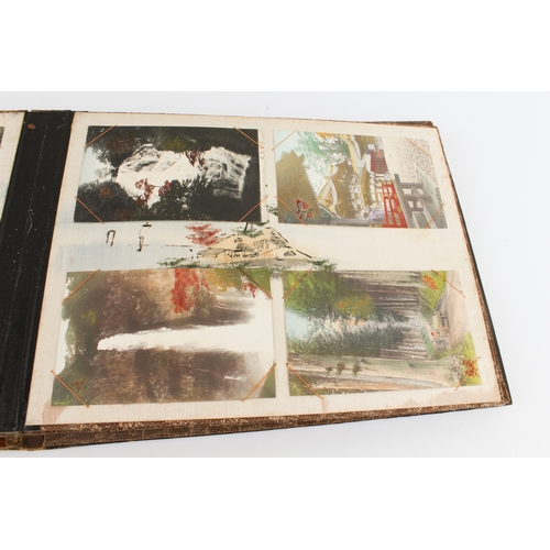 68 - A Japanese lacquer postcard album - 1920s-30s, the black lacquer cover decorated with a handpainted ... 