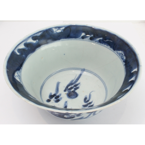 57 - An 18th century Chinese porcelain bowl with slightly everted rim, the interior with stylised flaming... 