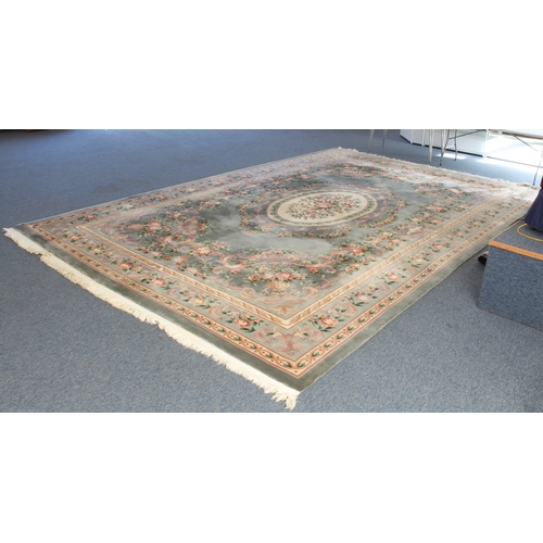 592 - A Chinese carpet with a teal ground, ivory central medallion surrounded by vases of flowers, one mai... 