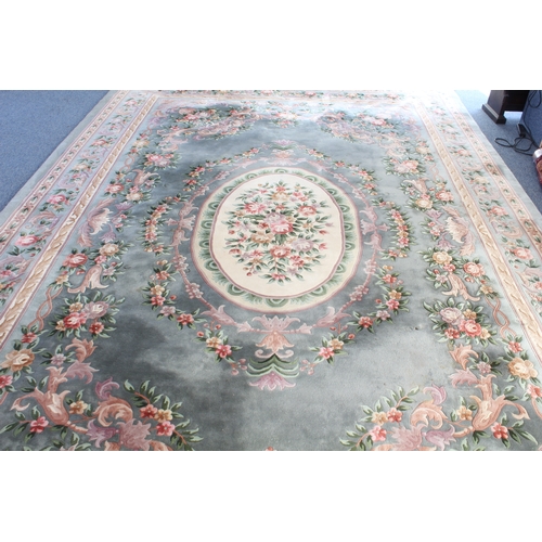 592 - A Chinese carpet with a teal ground, ivory central medallion surrounded by vases of flowers, one mai... 