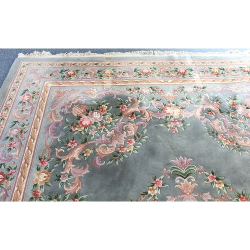 592 - A Chinese carpet with a teal ground, ivory central medallion surrounded by vases of flowers, one mai... 