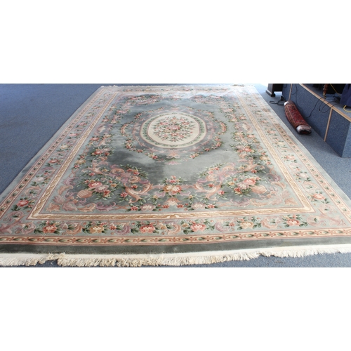 592 - A Chinese carpet with a teal ground, ivory central medallion surrounded by vases of flowers, one mai... 