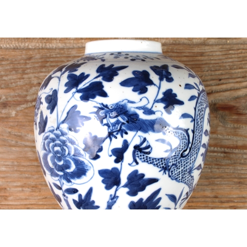 35 - A Chinese blue-and-white ginger jar and cover decorated with dragons between foliage and painted fou... 