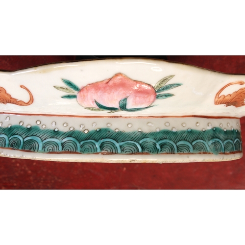 64 - A 19th century Chinese lozenge-shaped pedestal dish decorated in enamels: seated male figure dressed... 