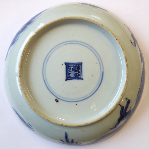 51 - Ming Dynasty (1368-1644) - a Chinese porcelain dragon dish: four-clawed dragon in underglaze blue fl... 