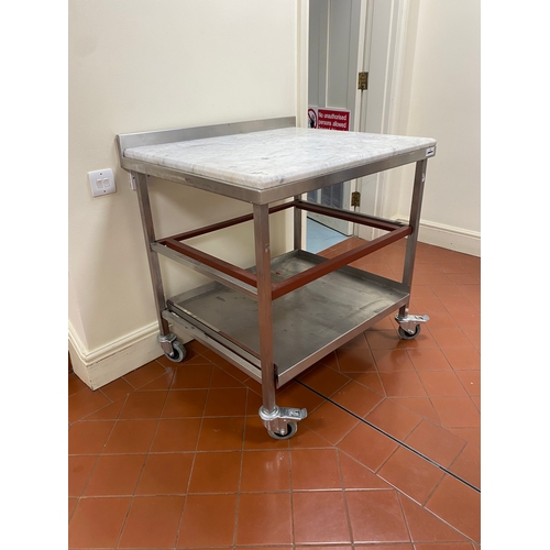 1 - 25mm thick Marble topped, freestanding, stainless steel trolley. On four caster wheels with two lowe... 