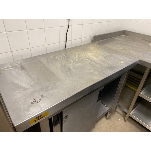 12 - Stainless steel worksurface with a lockable cabinet below. Cabinet has two sliding doors and one int... 