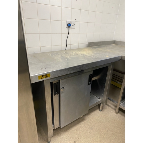 12 - Stainless steel worksurface with a lockable cabinet below. Cabinet has two sliding doors and one int... 