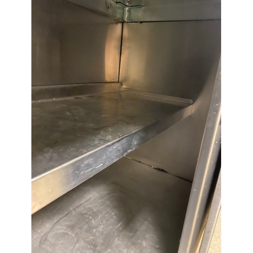 12 - Stainless steel worksurface with a lockable cabinet below. Cabinet has two sliding doors and one int... 