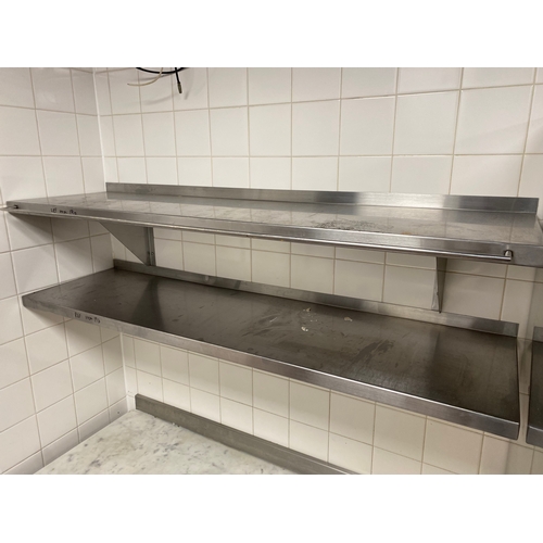 20 - Two stainless steel shelves. One shelf has a wire hanging rail on the front. 
 1500mm L 400mm D 
 Br... 