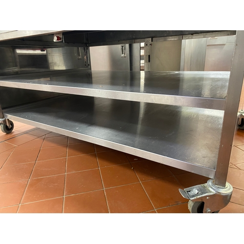 22 - Two stainless-steel, free-standing work units. Two lower shelves with two end draws. On four caster ... 