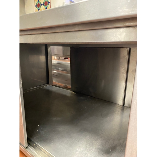 23 - Free-standing stainless-steel work unit. Sliding lockable doors on either side of unit and is on fou... 