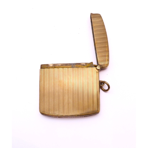 119 - A George V 9ct gold vesta case - William Neale & Son Ltd., rectangular with curved ends, with engine... 