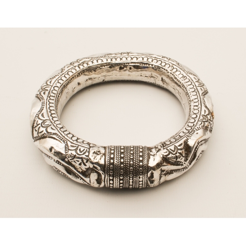 202 - An Indian silver dancer's rattling armband or bangle, 11 cm in diameter, (107 g)