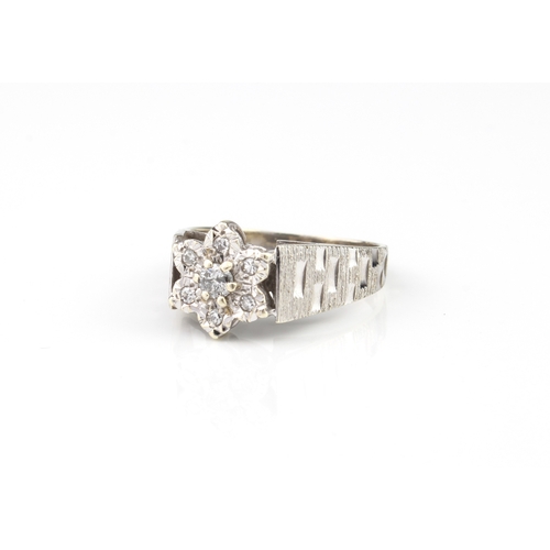 211 - A vintage 9ct white gold and diamond cluster ring - hallmarked Sheffield 1978, the central brilliant... 