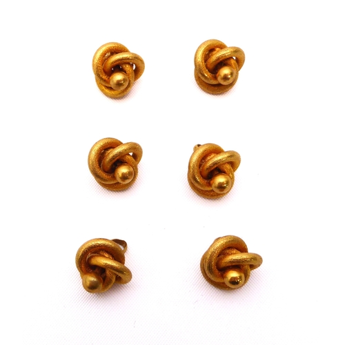 235 - A cased set six Edwardian 9ct gold shirt studs - of knot form, in brushed gold, each stud 12mm wide,... 