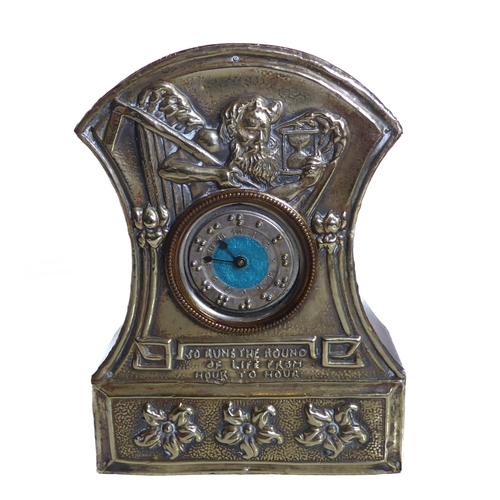 262 - An Arts and Crafts mantle clock; the face silver plated with embossed design of Old Father Time and ... 