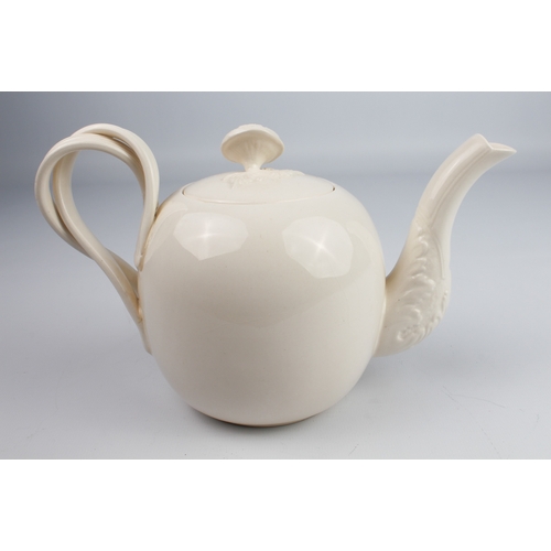 29 - A reproduction Wedgwood creamware teapot and a Wedgwood buff-glazed three-piece cruet set