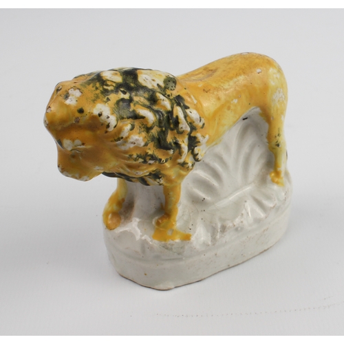 3 - A small 19th century century Staffordshire figure of a lion - painted yellow and black over a pearlw... 