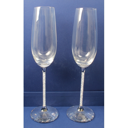 43 - A set of eight Swarovski Crystalline champagne toasting flutes - each glass with an elongated ovoid ... 