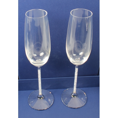 43 - A set of eight Swarovski Crystalline champagne toasting flutes - each glass with an elongated ovoid ... 