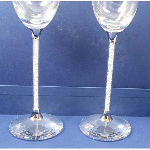 43 - A set of eight Swarovski Crystalline champagne toasting flutes - each glass with an elongated ovoid ... 