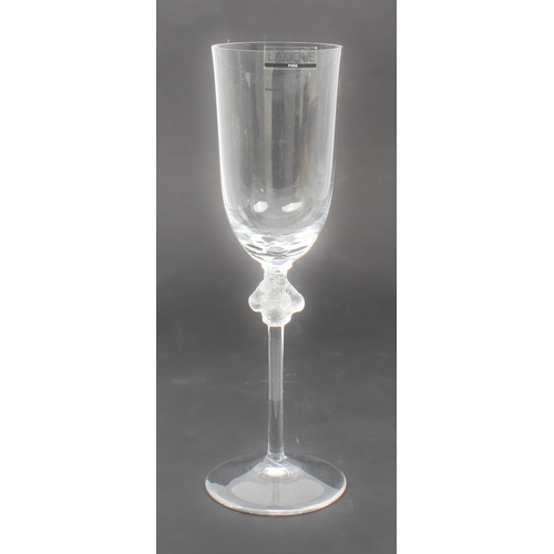 45 - A set of six Lalique Roxane crystal champagne flutes - the round funnel-shaped bowls with basal peta... 